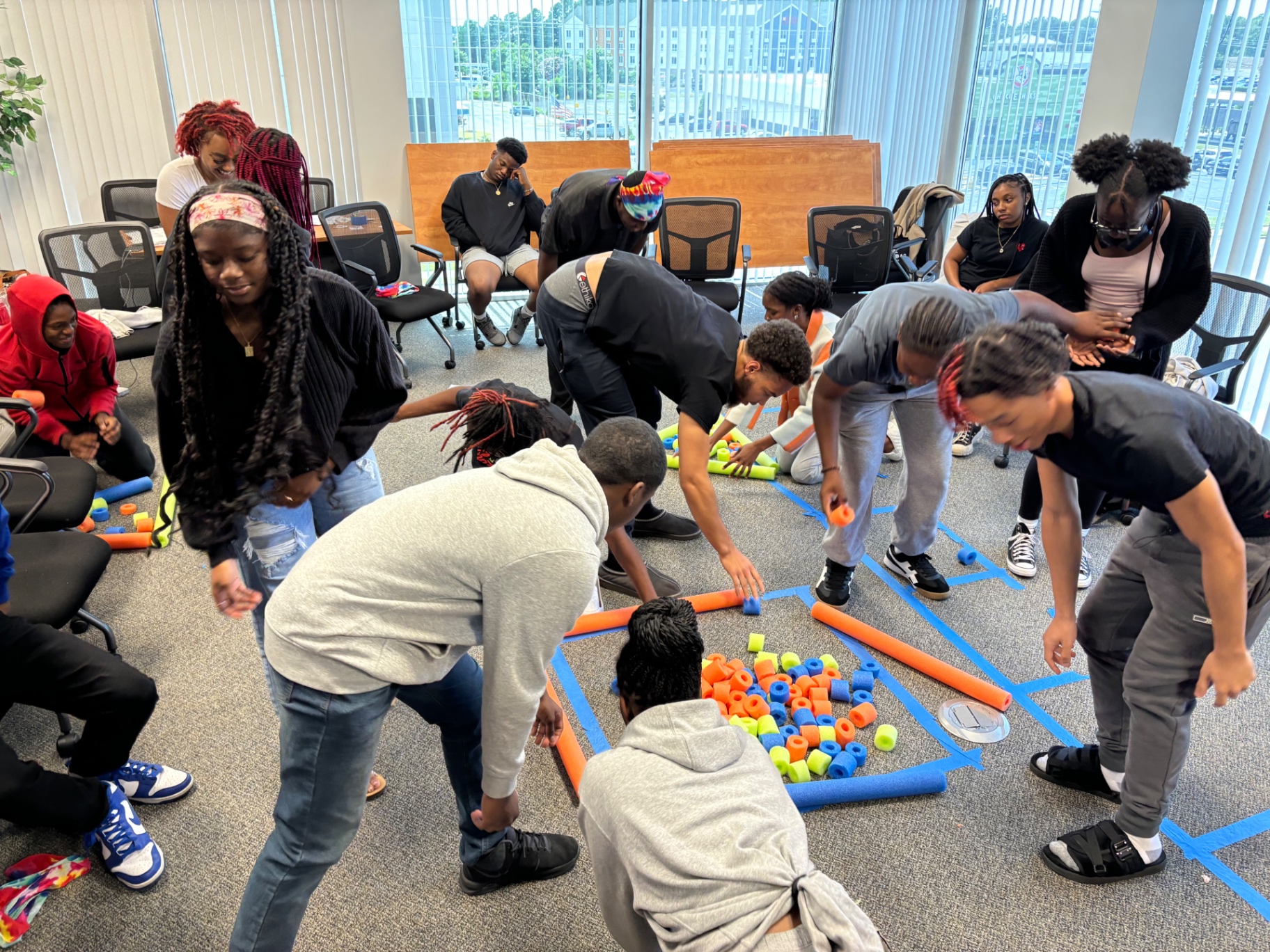 Youth collaborating on a hands-on team activity