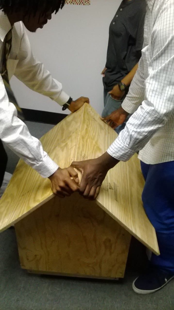 Students assembling a birdhouse together