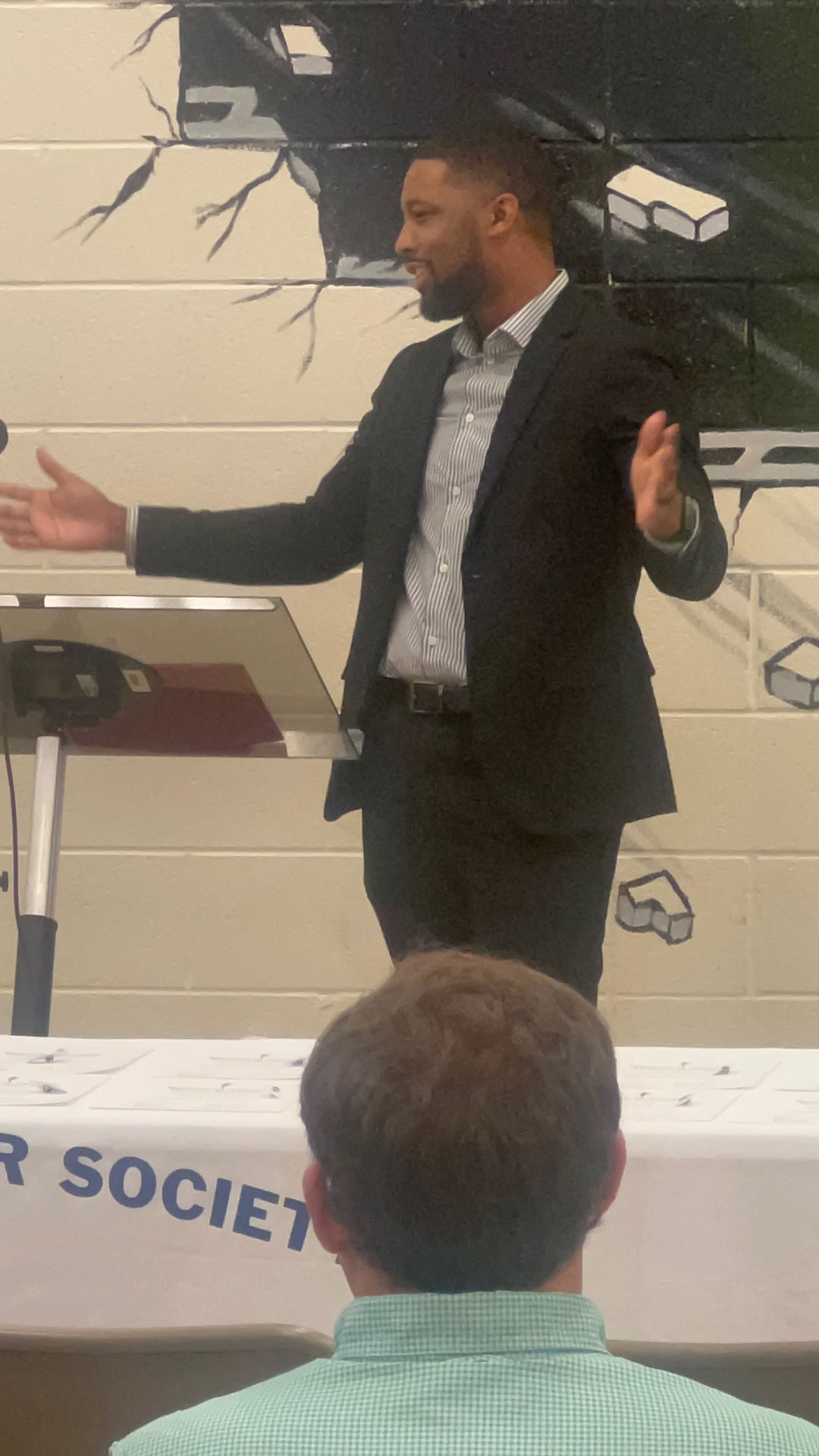 Xavier DeBrough speaking to an honor society