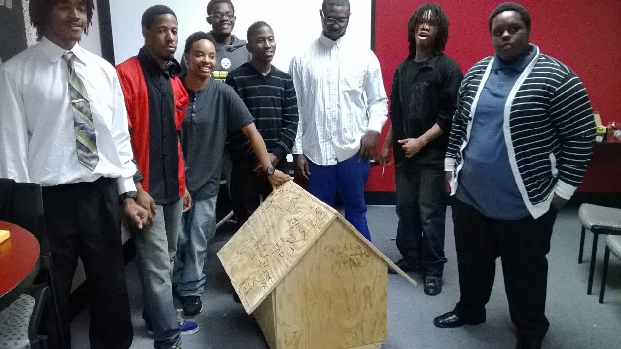 Youth cohort with a birdhouse they built