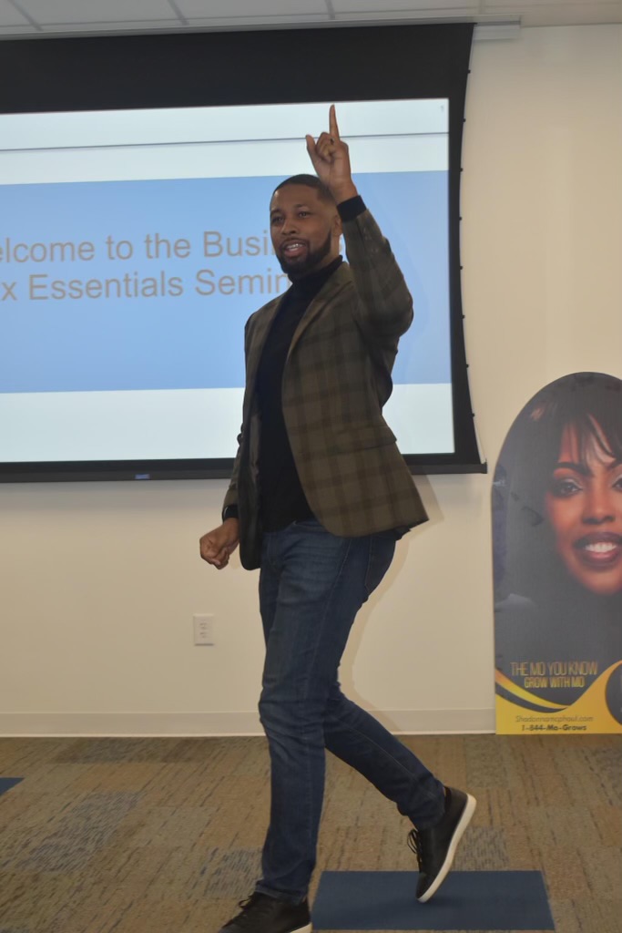 Xavier DeBrough presenting a business essentials seminar