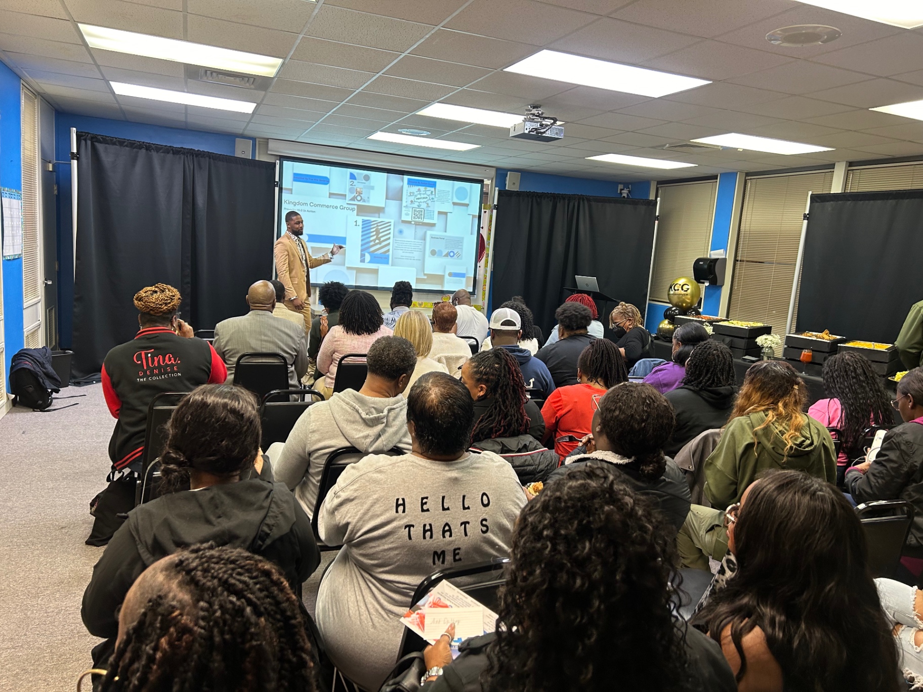 Xavier DeBrough presenting to a full room